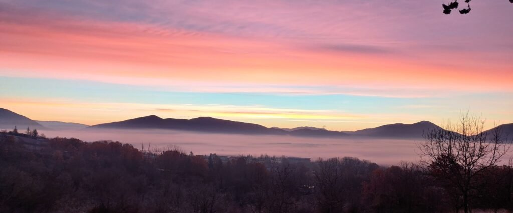 early sunrise pink sky over the mountains